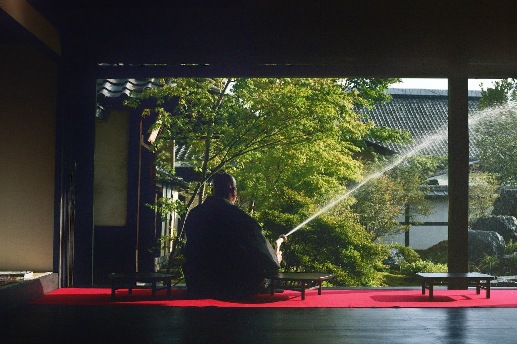 The abbot is watering flowers at a temple in Kyoto